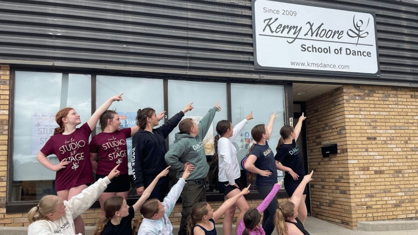 KMSD Dancers pointing at the building sign downtown Hanover